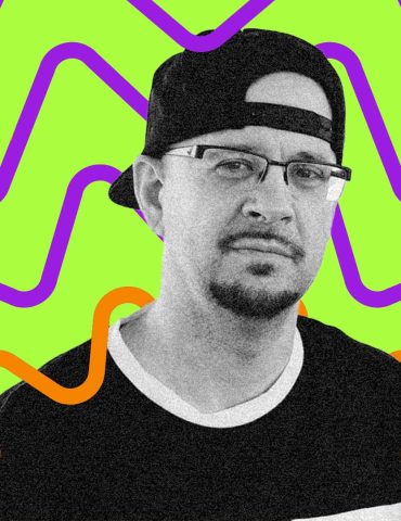 DJ Creativity looks directly at the camera with pensive expression