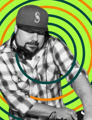 DJ Tamm t plays while holding headphones in place with shoulder