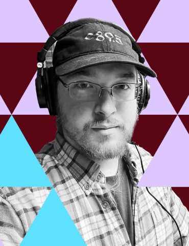 William Mayfield looks at the camera with pensive expression, wearing c89.5 baseball cap