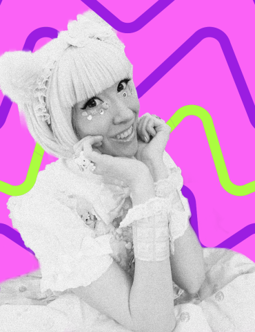 DJ Jimni Cricket smiles while resting chin on hands in vibrant lacey attire