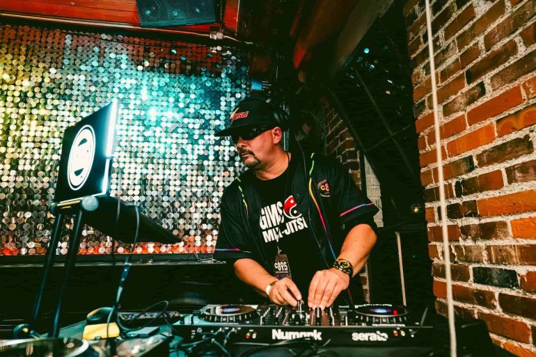 A DJ set up against a sparkling backdrop